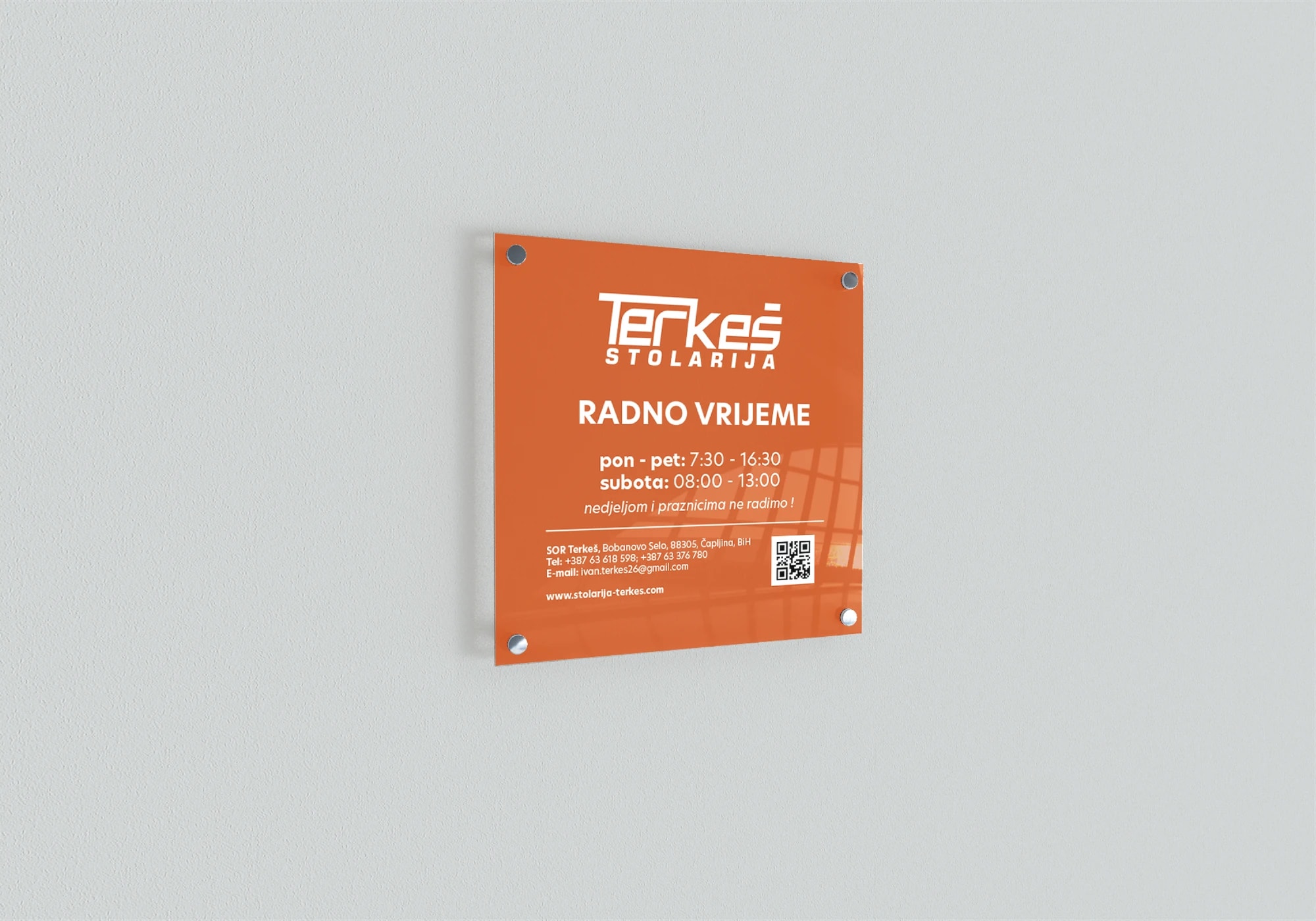 Orange entrance sign for Stolarija Terkeš with opening hours, contact details and a QR code